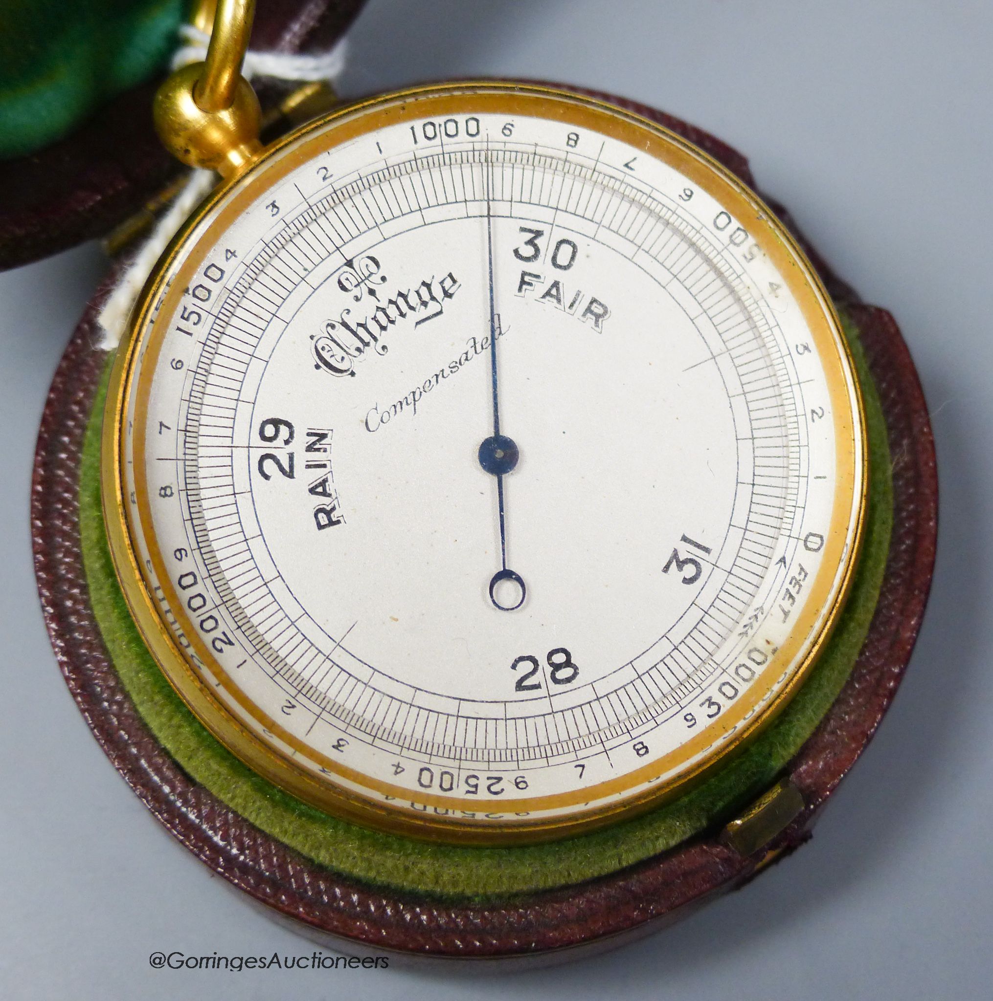 A 19th century gilt brass cased pocket barometer with compass, cased